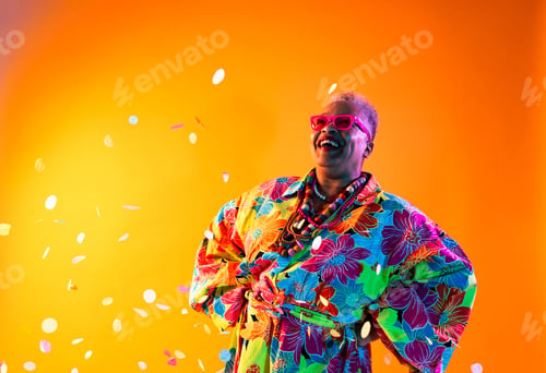 Preview: Happy senior woman laughing celebrating with confetti