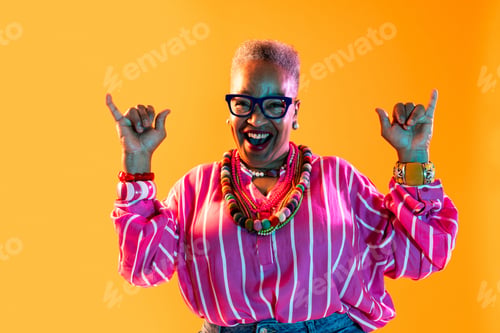 Preview: Happy senior black woman gesturing shaka sign