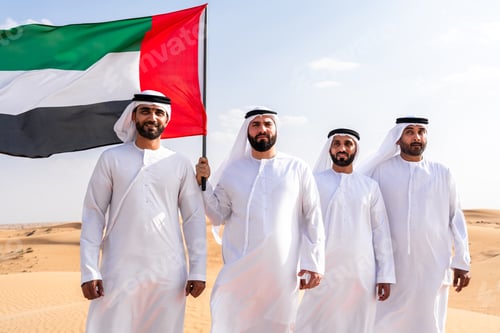 Preview: Group of middle-eastern men wearing traditional emiratis clothing and bonding in Dubai desert