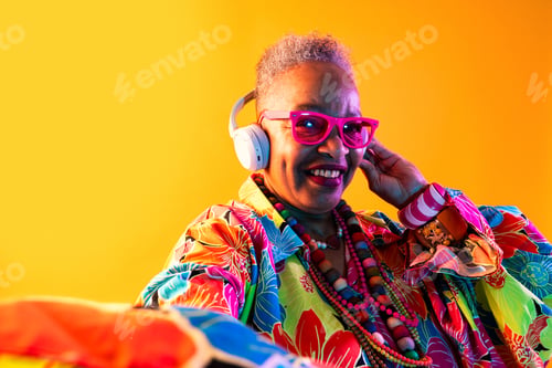Preview: Senior woman enjoying music wearing colorful clothes