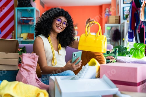 Preview: Beautiful young hispanic woman managing her home e-commerce business from home