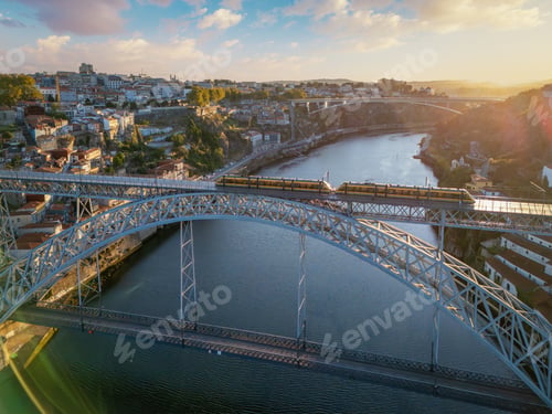 Preview: Sunrise drone view of tram on Dom Luis I Bridge with old town skyline