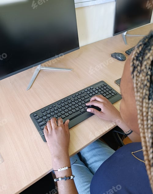 Preview: A Young Black Woman, a University Student Working at a Computer