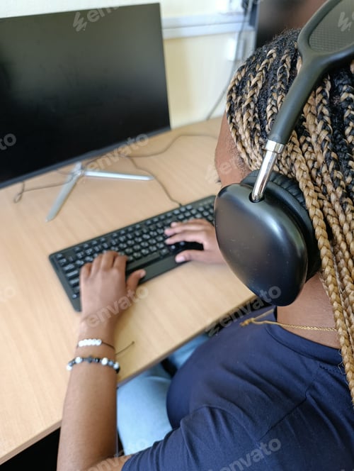 Preview: A Young Black Woman, a University Student Working at a Computer