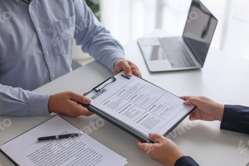 Preview: Business People Reviewing Resume During Job Interview Meeting.