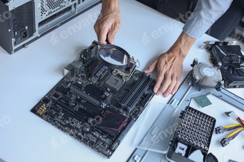 Preview: Close up of electronic technician hands working on computer hardware and mainboard repair.