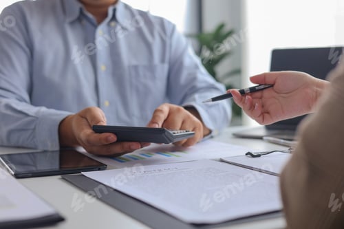 Preview: Business Partners Brainstorming Calculating Analyzing Financial Data for Budget Planning Strategy.