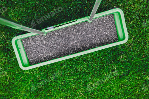 Preview: Green Lawn Roller with Textured Surface on Vibrant Grass Under Clear Sky