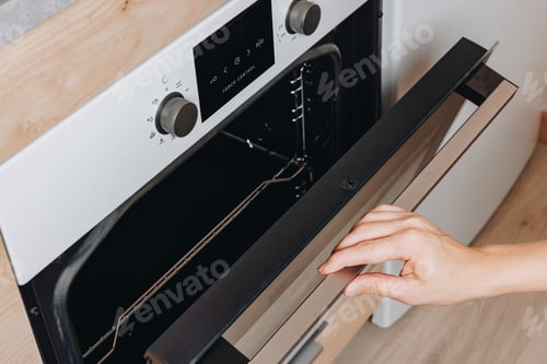 Preview: Oven door opening to reveal interior metal racks, digital control panel, and sleek design