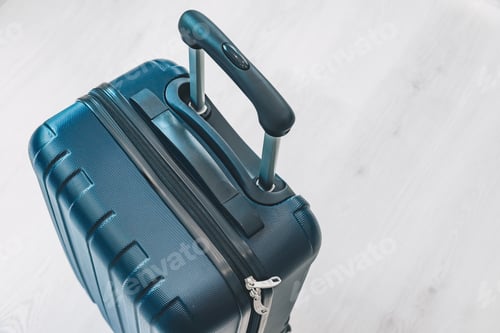 Preview: Hard shell suitcase with retractable handle and textured exterior on light wooden flooring
