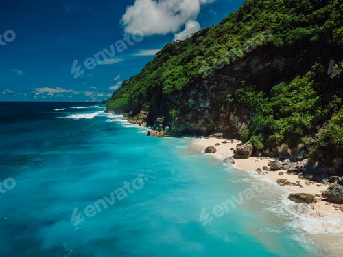 Preview: Bali cliff and turquoise bay with sand beach and clear ocean water.