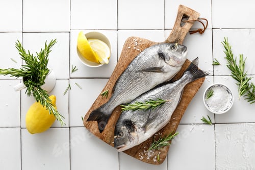 Preview: Fresh raw dorado fish cooking with ingredients. Sea bream, dorado. Seafood, healthy food. Top view