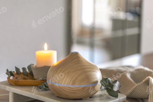 Preview: Aroma diffuser in modern minimal interior creating relaxing wellness atmosphere. Home spa diffuser.