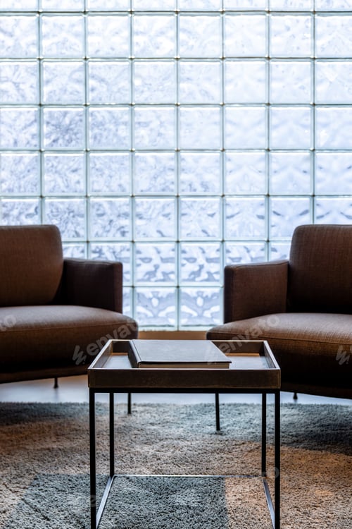 Preview: Bright living room with glass blocks. Coffee table and armchairs in modern interior.