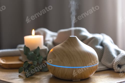 Preview: Modern wooden aroma diffuser releasing mist in cozy wellness home interior. Diffuser device.