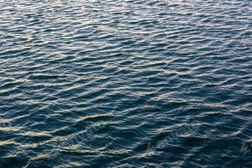 Preview: Sea water texture in evening light. Small ripples on blue ocean surface.
