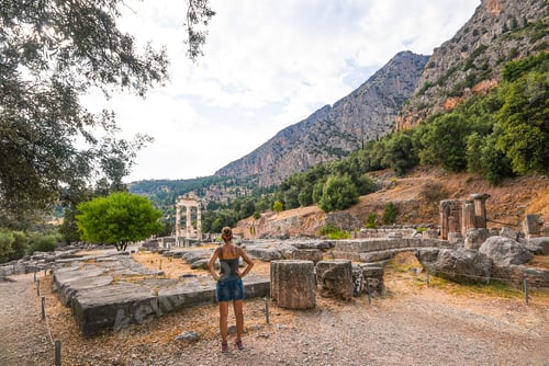 Preview: Woman exploring ancient Greek ruins at Delphi sanctuary
