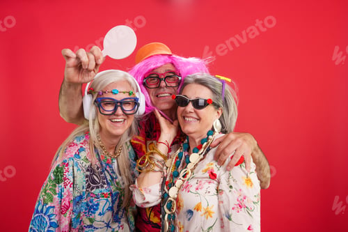 Preview: Cheerful mature adults having fun wearing funny costumes