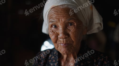 Preview: Weathered elderly asian woman wearing traditional headscarf, deep wrinkles revealing profound life s