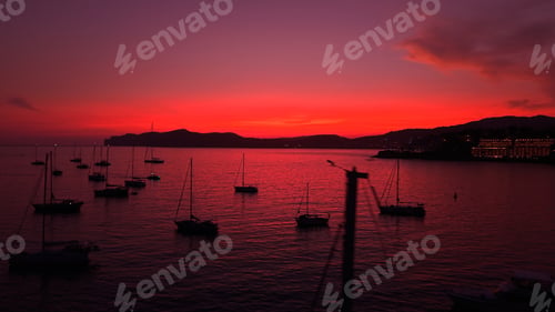 Preview: Mallorca bay sunset with anchored sailboats and dramatic red sky