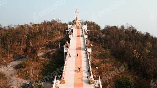 Preview: Golden buddha statue atop chiang mai mountain temple with ascending staircase