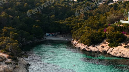 Preview: Cala mago cove with turquoise water and green pine forests