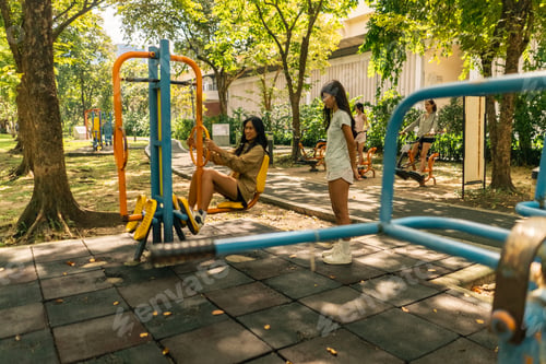 Preview: Young women exercising in an outdoor park gym, engaging in fitness activities