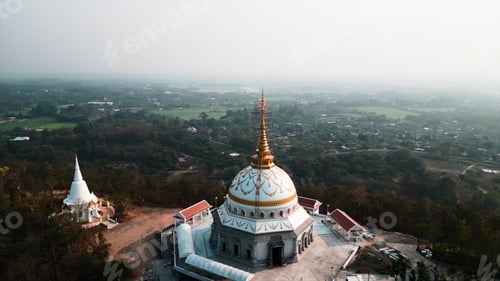 Preview: Buddhist temples standing on a mountain overlooking a rural chiang mai landscape