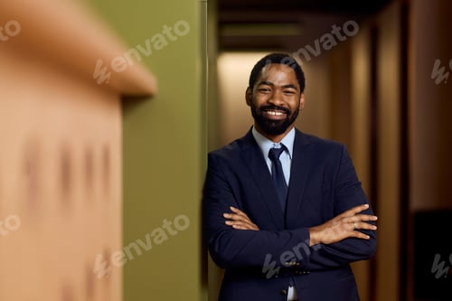 Preview: Confident Businessman Posing in an Office Corridor with a Professional Smile