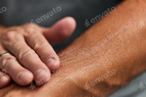 Preview: Focus on the glowing hydrated skin, after putting a lotion on the man's hand.