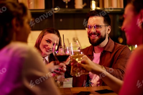 Preview: Group of Friends Celebrating Together with Drinks in a Relaxed Evening Setting