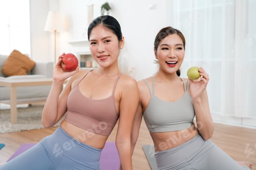 Preview: Women exercise, holding fruit, smiling, indoor fitness