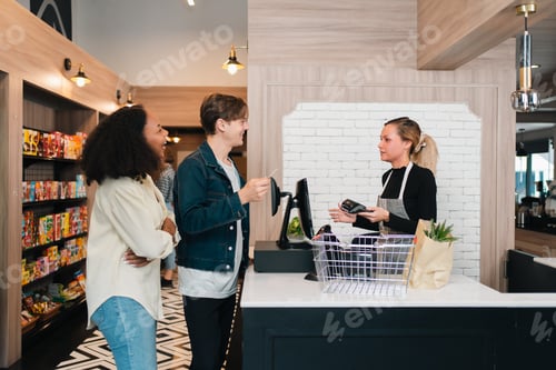 Preview: Checkout counter retail store young adult cashier customer shopping store interior payment queue