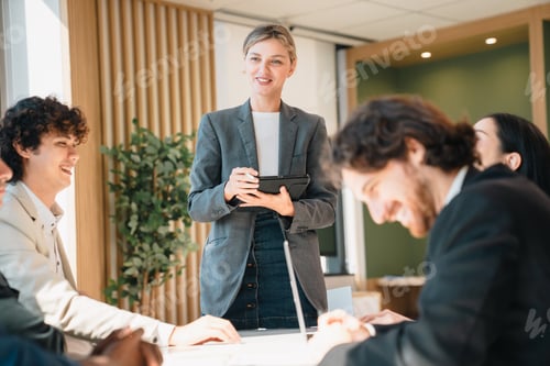 Preview: Business meeting in office with smiling team and presenter
