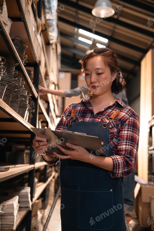 Preview: Warehouse worker checking inventory in storage aisle