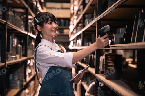 Preview: Warehouse worker scanning inventory in shelf aisle