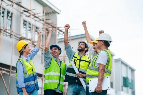 Preview: Construction team celebrating success at building site