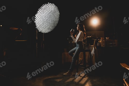 Preview: Studio lighting portrait of woman holding cup