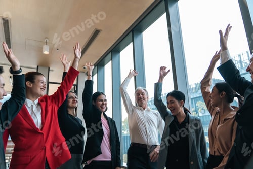 Preview: Office team celebration with raised hand and happy smile