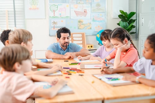 Preview: Teacher student classroom child drawing adult teacher guiding child student drawing bright