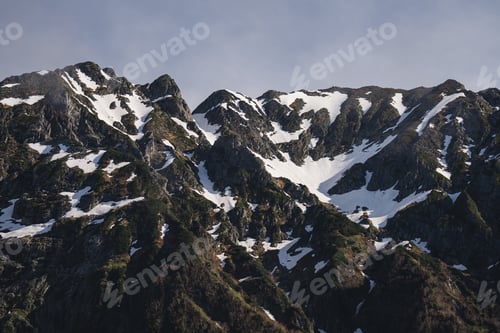 Preview: Mountain snow peak ridge rock alpine rugged mountain range with snow under clear sky