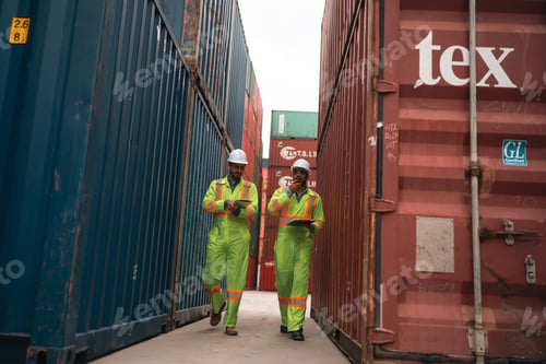 Preview: Workers walking between container row in freight yard