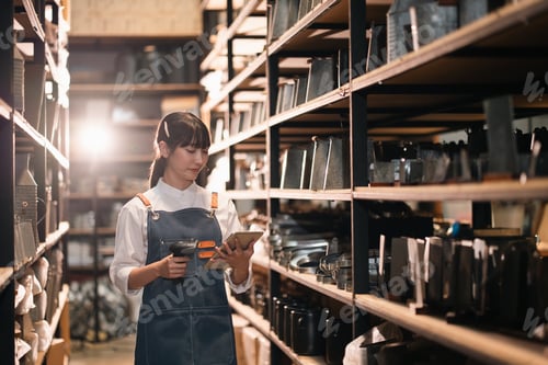 Preview: Warehouse inventory checking woman with tablet and scanner