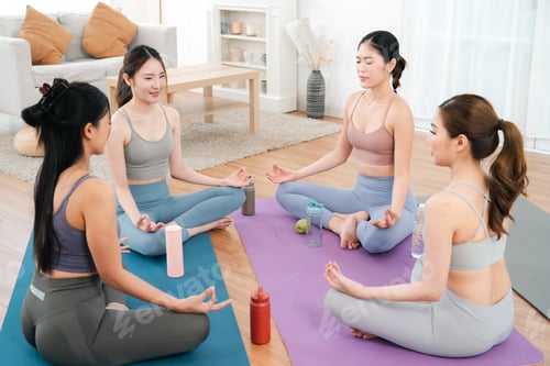 Preview: Meditation group in bright living room with yoga mat and calm pose