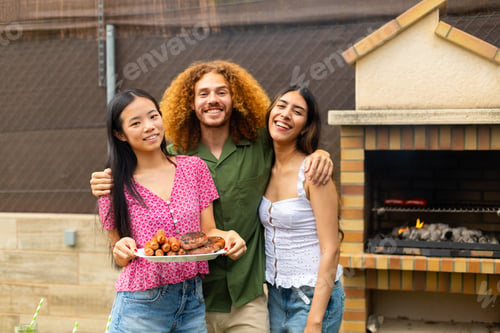 Preview: Happy friends showing grilled food at barbecue party