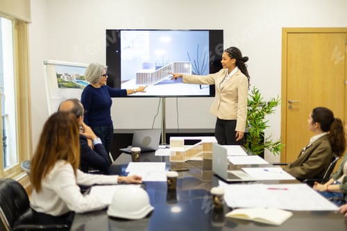 Preview: Architects discussing building design during studio meeting