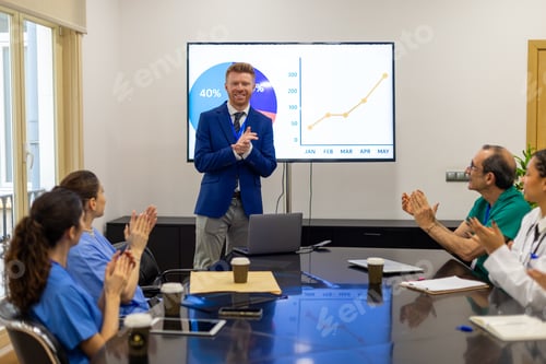 Preview: Medical team applauding during business presentation achieving success