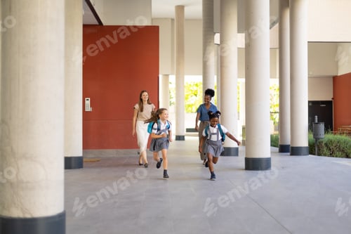 Preview: Diverse student girls running with teachers at school