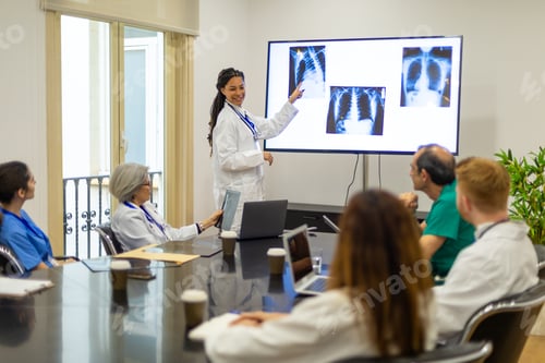 Preview: Doctors discussing medical imaging during hospital presentation