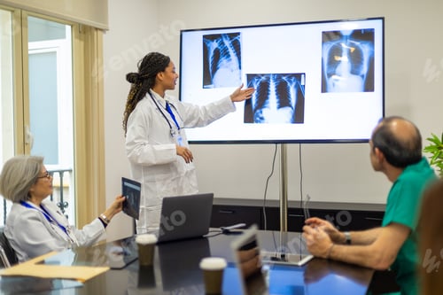 Preview: Doctors discussing patient x rays during medical briefing